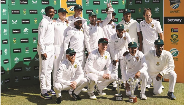 Captain Dean Elgar (top centre) holds the trophy as the South African team poses for a photo following the second Test against Bangladesh at St Georgeu2019s Park in Gqeberha yesterday. (AFP)