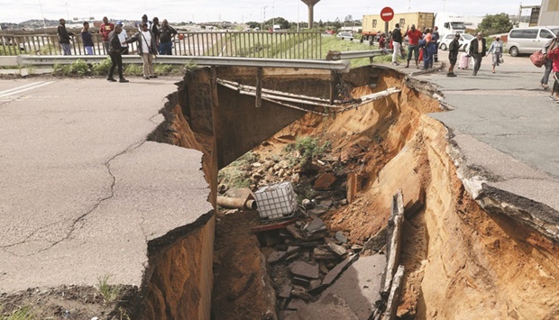 A major crack is seen in the road following heavy rains and winds yesterday in the port city of Durban, South Africa.