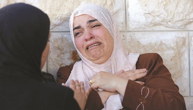 A relative of Palestinian lawyer Mohamed Assaf reacts during his funeral in the village of Kafr Laqif near Qalqilya in the northwest of the occupied West Bank, yesterday.