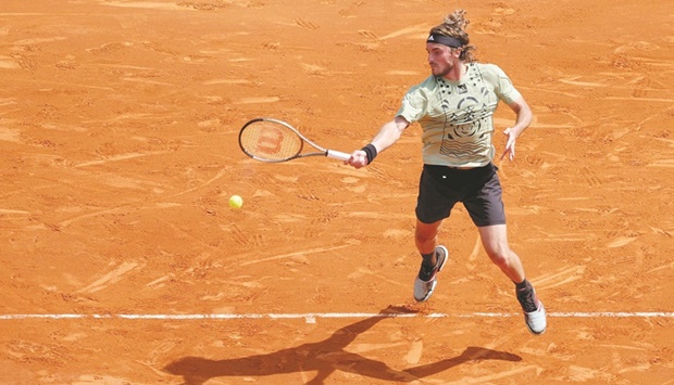 Greeceu2019s Stefanos Tsitsipas returns the ball to Serbiau2019s Laslo Djere during their Monte-Carlo ATP Masters Series match in Monaco yesterday. (AFP)