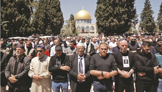 Palestinians pray at the compound that houses Al-Aqsa Mosque, following clashes with security forces in Jerusalemu2019s Old City, yesterday.