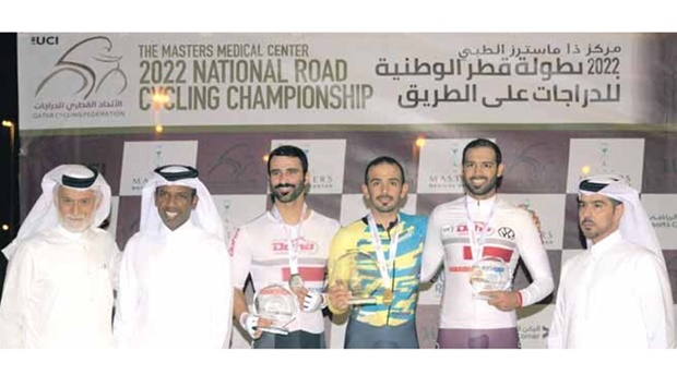 Top three finishers from the menu2019s category of the National Time Trial Championship pose with the officials.