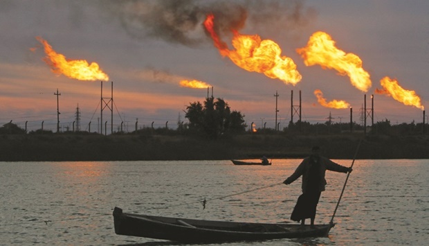 Flames emerge from flare stacks at the oil fields in Basra, Iraq. Iraq will probably sell its oil for an average of $106-107 a barrel this month if prices remain at current levels, Oil Minister Ihsan Abdul Jabbar said.