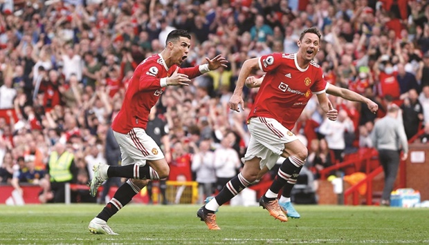 Manchester Unitedu2019s Cristiano Ronaldo celebrates scoring their third goal with Nemanja Matic against  Norwich City at Old Trafford, Manchester, on April 16, 2022. (AFP)