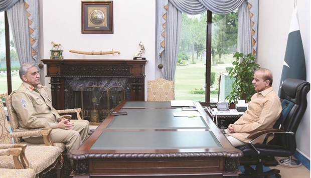 Prime Minister Shehbaz Sharif (right) speaks with Army Chief General Qamar Javed Bajwa at the Prime Minister House in Islamabad yesterday. (AFP)