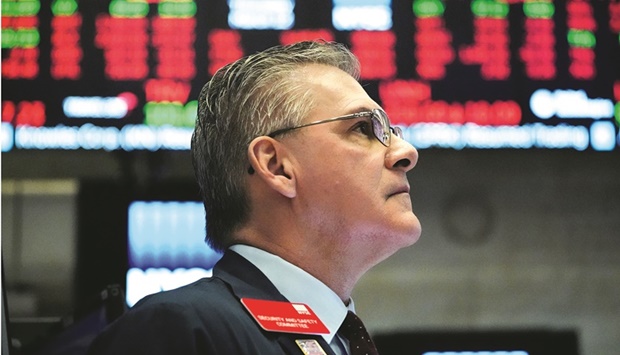 A trader works on the floor at the New York Stock Exchange (file). The odds of a major market sell-off would be increased if monetary policy tightening is combined with a recession, said Tobias Adrian, director of the IMFu2019s monetary and capital markets department and a former senior vice president of the Federal Reserve Bank of New York.