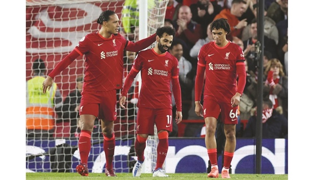 Liverpoolu2019s Mohamed Salah (centre) celebrates with teammates after scoring against Manchester United during the Premier League match at Anfield in Liverpool on Tuesday night. (Reuters)