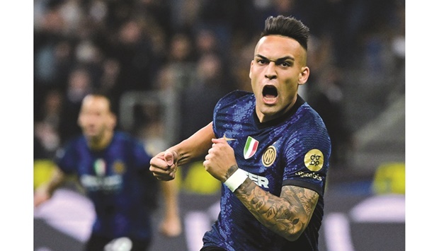 Inter Milanu2019s Lautaro Martinez celebrates scoring their second goal against AC Milan during the Coppa Italia semi-final second leg match at San Siro in Milan, Italy, on Tuesday night. (Reuters)