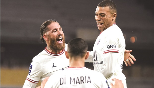 Paris Saint-Germainu2019s Sergio Ramos (left) celebrates with Kylian Mbappe (right) and Angel Di Maria after scoring against Angers during the French Ligue 1 match at the Raymond-Kopa Stadium in Angers, north-western France, on Wednesday night. (AFP)