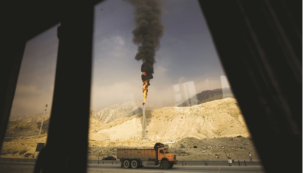 A gas flame is seen through a bus window in the South Pars gas field facilities in the southern Iranian port of Assaluyeh (file). Iran holds the worldu2019s biggest proven gas reserves after Russia. But it may be forced to import the fuel in the coming years, Oil Minister Javad Owji said.