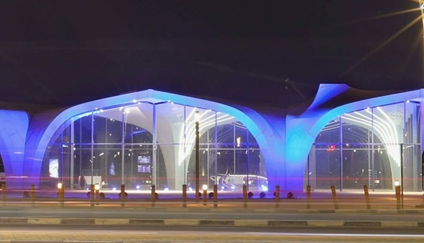 The Corniche Metro station lit up in blue.