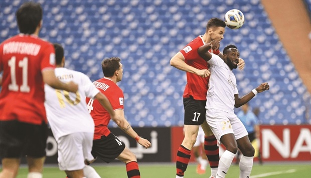 Al Rayyan's Yohan Boli (right) and Istiklol's Uladzislaw Kasmynin vie for the ball during the AFC Champions League group stage match in Riyadh Saturday.
