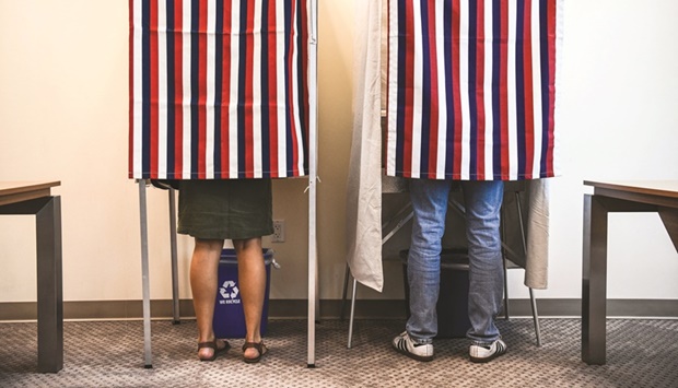 People vote in the second round of the French elections at the French Consulate in Miami yesterday.