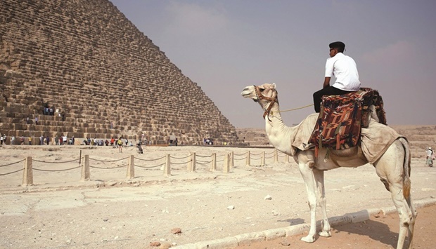 A policeman rides a camel while guarding the site at the pyramids plateau in Egypt (file). Along with Suez Canal receipts and remittances, the tourism sector has traditionally been one of Egyptu2019s prime foreign-currency earners.