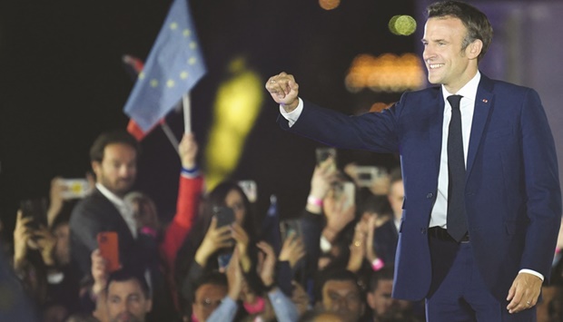 French President Emmanuel Macron celebrates after his victory in the presidential election, at the Champ de Mars in Paris yesterday.