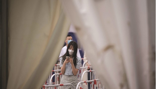 People queue to be tested for Covid-19 coronavirus at a swab collection site in Beijing. On Monday, investors awoke to the idea of China locking down Beijing u2013 a city of more than 20mn people u2013 adding to worries about supply stresses that are keeping the heat on prices.