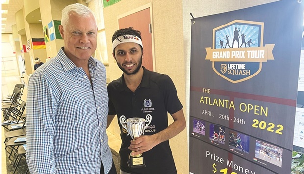 Abdulla al-Tamimi (right) poses with the Atlanta Open trophy.