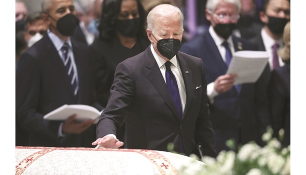 President Joe Biden places his hand on the casket of former secretary of state Madeleine Albright during her funeral at the Washington National Cathedral yesterday. (AFP)