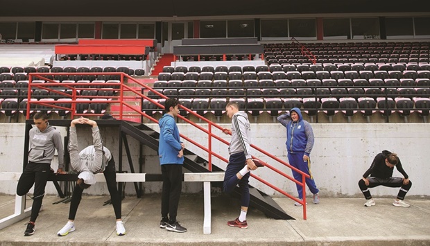 Ukrainian athletes warm up before a training session at the Elbasan Arena stadium, in Elbasan, central Albania. (AFP)