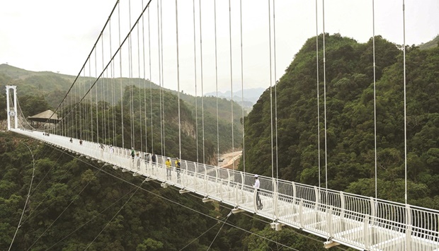 Visitors are seen on the Bach Long glass bridge in Moc Chau district in Vietnamu2019s Son La province.