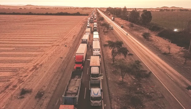 Buses are parked along the Pan-American highway during a road blockade as part of a partial strike of cargo and passenger carriers, in Ica, in southern Peru, on Monday. The partial strike of cargo and passenger carriers caused road blockades and suspension of classes in Peru, in the first strike against the government of leftist President Pedro Castillo.