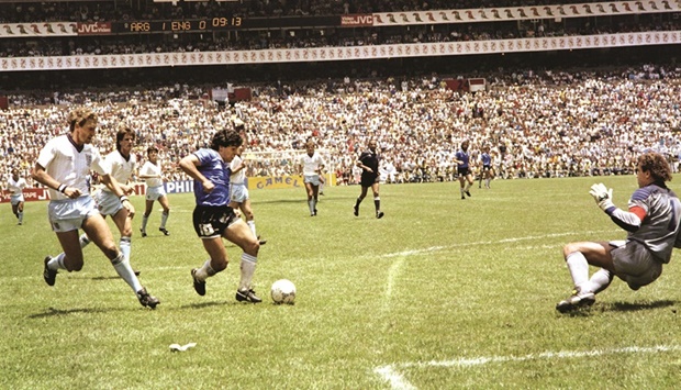In this file photo from June 22, 1986 Argentinau2019s Diego Maradona (third left) runs past English players during the World Cup quarter-final in Mexico City. (AFP)