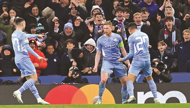 Manchester Cityu2019s Kevin De Bruyne (centre) celebrates with Joao Cancelo (right) and Phil Foden after scoring against Atletico Madrid in the Champions League quarter-final first leg on Tuesday. (AFP)