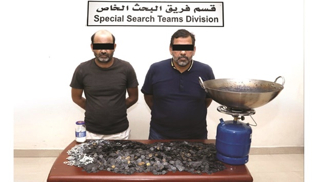 The two arrested persons along with the items seized from them.