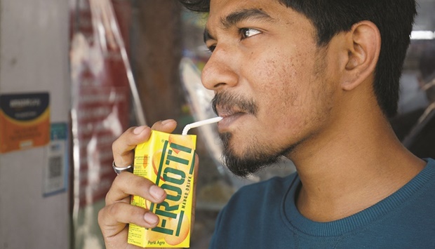 A man consumes Parle Agrou2019s Frooti mango flavoured drink outside a shop in Ahmedabad, yesterday.