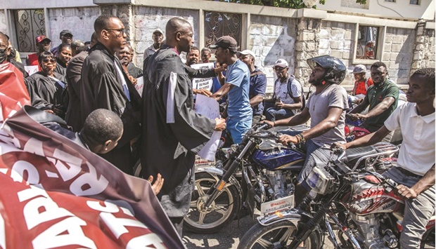 Lawyers block a street during their protest in Port-au-Prince, outside of Prime Minister Ariel Henryu2019s private home, to force the government to relocate the civil court to a safer area.