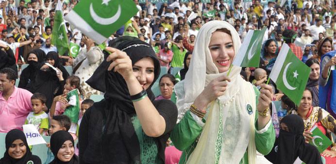 Pakistanis attend a flag hoisting ceremony to celebrate Independence Day on the Pakistan-India border at Wagah yesterday.