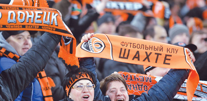 Fans of FC Shakhtar football team react during the UEFA Champions League, Round 16, match against Borussia Dortmund in Donetsk on Wednesday. (AFP)