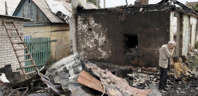 A man cries outside his damaged house, which according to locals was caused by recent shelling, in Donetsk.