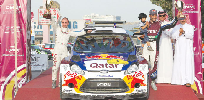 Nasser Saleh al-Attiyah and Gioranni Bernacchni celebrate winning the Qatar Rally in 2013.