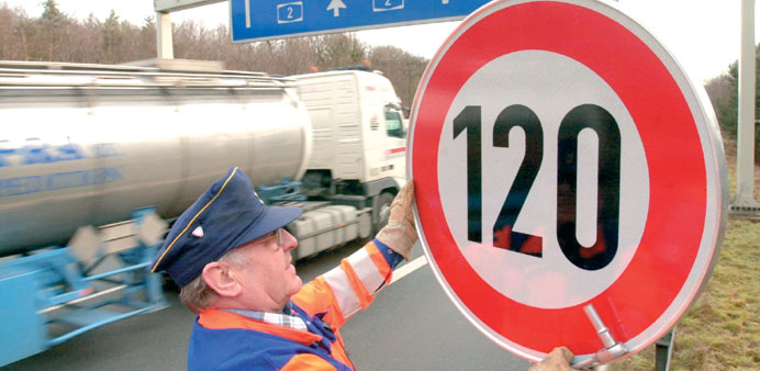 This 2002 file picture shows a man fixing a speed limit sign on the A2 highway near Hanover, central Germany.