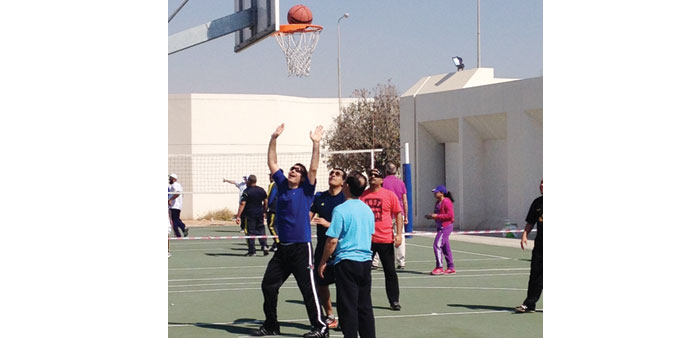 Qafac staff and their family members playing basketball.