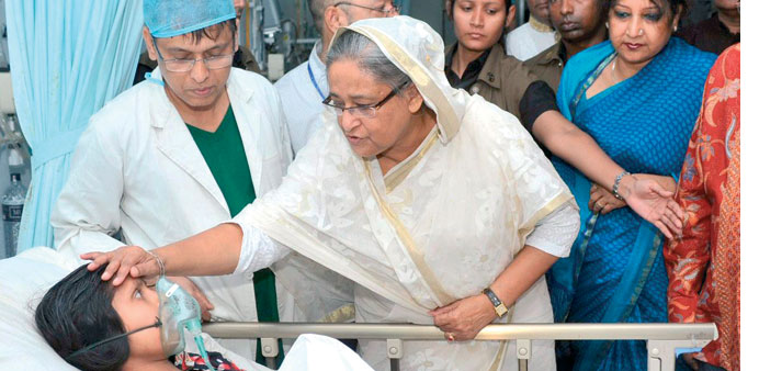 Bangladeshu2019s Prime Minister Sheikh Hasina comforts a garment worker as she visits the survivors of the collapsed Rana 