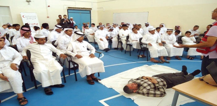 QRC presents a demonstration of first aid techniques to students.