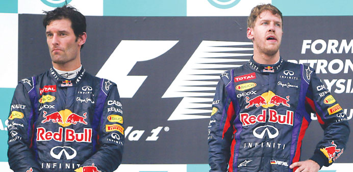 Red Bull drivers Mark Webber (left) and Sebastian Vettel stand on the podium at the end of the Malaysian Grand Prix at Sepang International Circuit ye