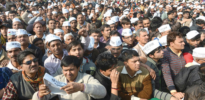 Supporters of Aam Aadmi Party attend the swearing-in ceremony of Arvind Kejriwal in New Delhi yesterday.