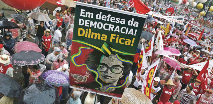 A demonstrator holds a banner with an image depicting Brazilu2019s President Dilma Rousseff during a demonstration in Sao Paulo on Friday.