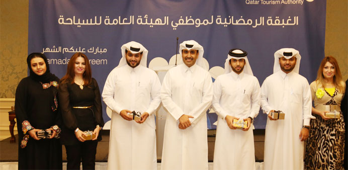 QTA chairman Issa bin Mohamed al-Mohannadi with the winners of the Ramadan competitions.