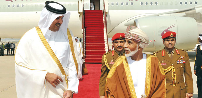 HH the Emir Sheikh Tamim bin Hamad al-Thani being received by Sultan Qaboos bin Saeed in Muscat yesterday.