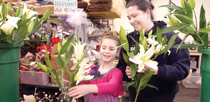 NO CHILDu2019S PLAY: Bella Carroto helps her mother, Loren, create a flower arrangement at the family business, Monessen Florist. Bella has paediatric kid