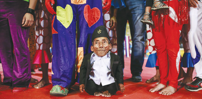 Chandra Bahadur Dangi, 75, poses for a picture with the artists of the Rambo Circus in Mumbai. 