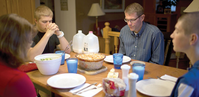 * Dave Thoen and his family at the dinner table. Seen in the photograph are his wife Denise, son Reese (left) and Riley.