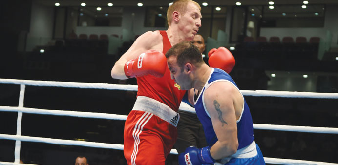 Qataru2019s 81kg light heavy boxer Hakan Murst Nuraydin (right) in action against Belarusian fighter Mihail Dauhaliavets during their preliminary round ma