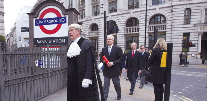 Colonel Geoffrey Godbold (left), the Common Cryer and Serjeant-at-Arms for the city of London, walks to the steps of the Royal Exchange Bank in centra