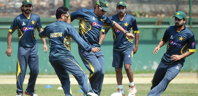 Pakistan captain Misbah-ul-Haq (centre) plays football with teammates during a practice session ahead of the Asia Cup final against Sri Lanka at the S