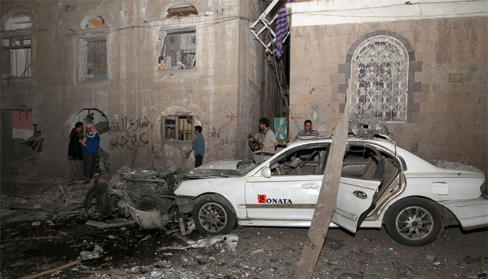 The wreckage of a car is seen at the site of a car bomb attack in the capital Sanaa on June 29, 2015. AFP 